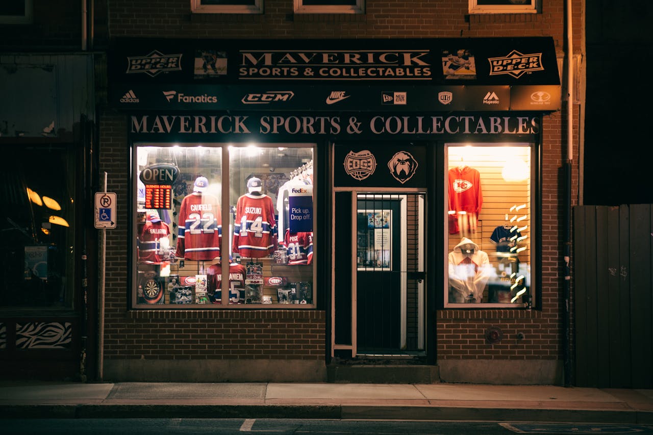 Crafting Captivating Headlines: Your awesome post title goes here Nighttime view of Maverick Sports & Collectables shop displaying sports jerseys and memorabilia.